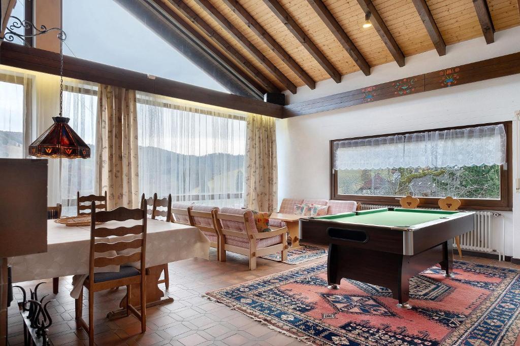 a living room with a pool table and a dining room at Deluxe Apartment Ferienwohnung in Wieden