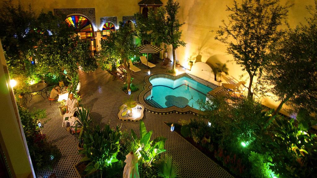 uma vista superior de uma piscina num jardim à noite em Ryad Salama em Fez