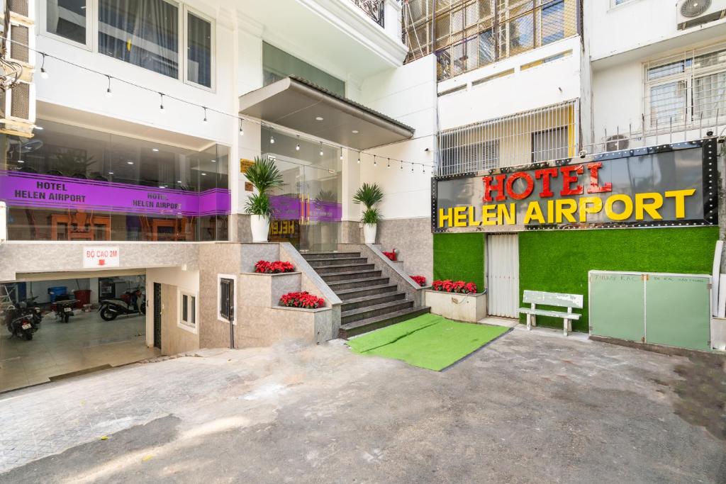 a hotel with a sign on the front of a building at Helen Airport Hotel in Ho Chi Minh City