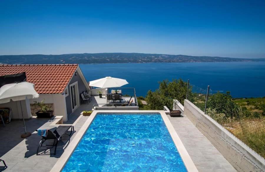 a swimming pool with a view of the water at Villa Panorama in Omiš