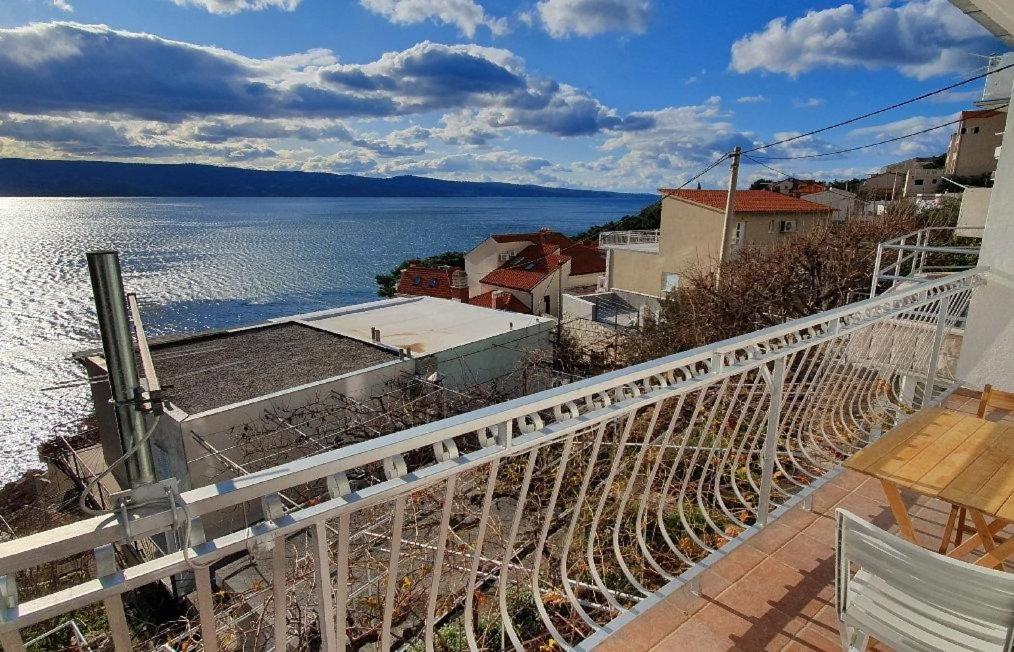a balcony with a view of a body of water at 205 Mata, 80m vom Strand in Stanići