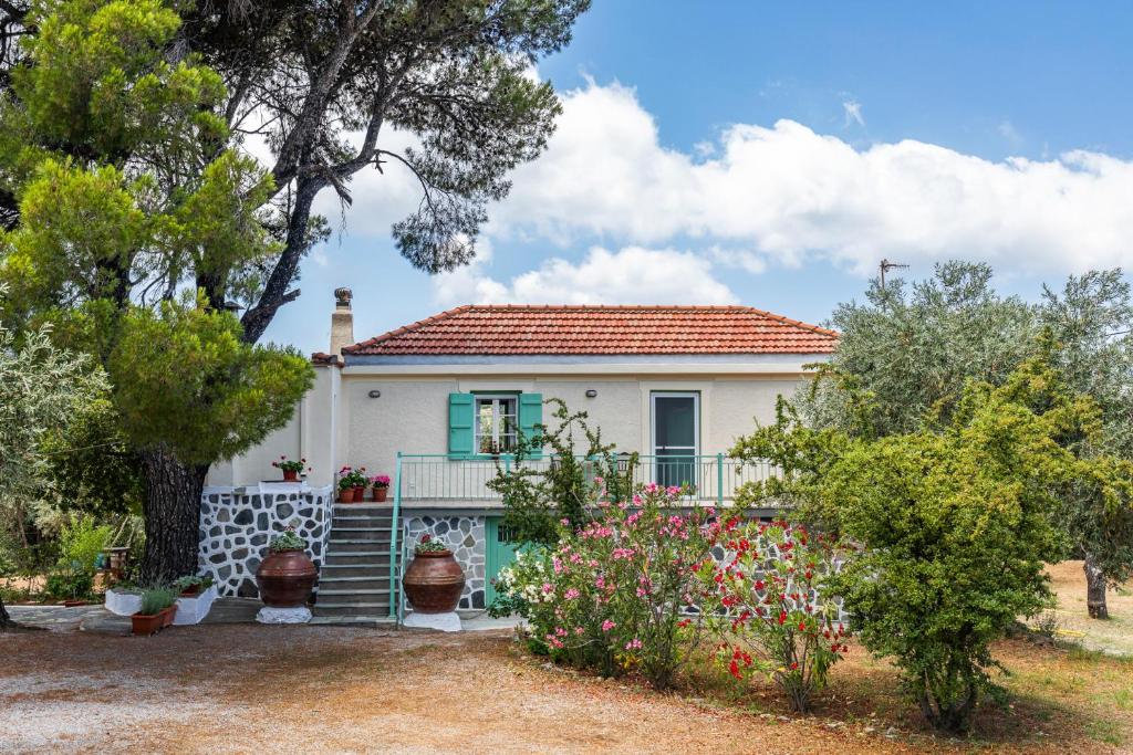 a white house with a red roof at Anemoperasma - Peaceful Stay in an Olive Grove in Stafylos