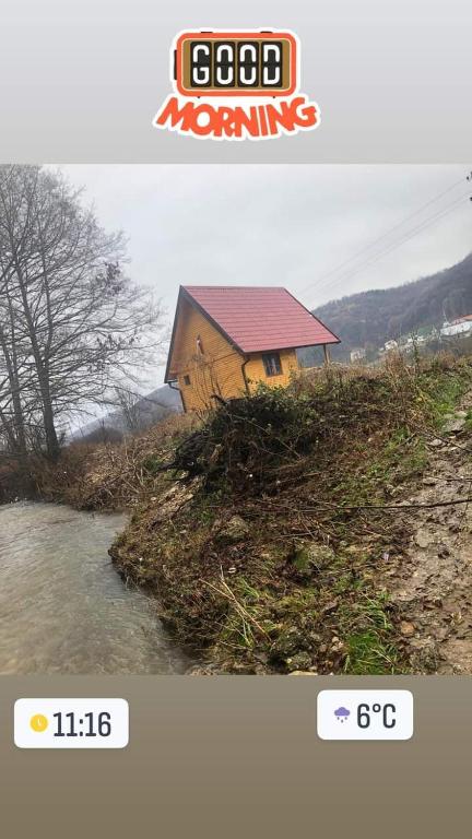 a picture of a house next to a river at Vikendica Tavna in Bijeljina
