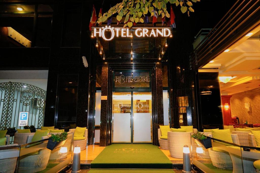 a hotel grand entrance to a restaurant with yellow chairs at Grand Hotel & Spa Tirana in Tirana