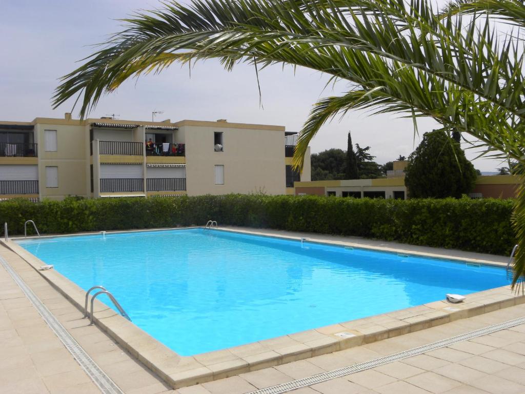 a large blue swimming pool in front of a building at Sun & Sea Apart in Bandol