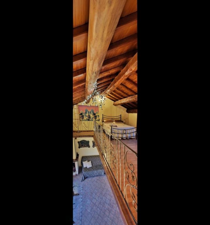 a living room with wooden ceilings and a table at Antica Rupe 80 mq Casa Vacanze in Castel SantʼElia