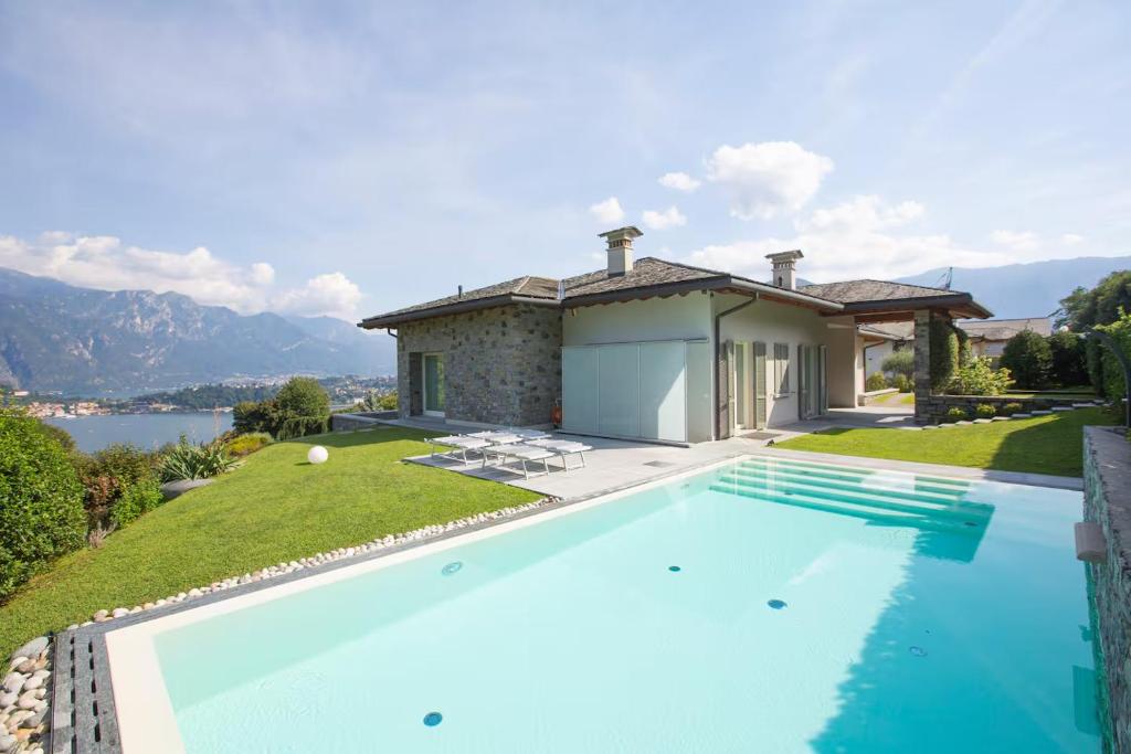 a swimming pool in front of a villa at Villa Miraggio by MyVillaCollection in Tremezzo