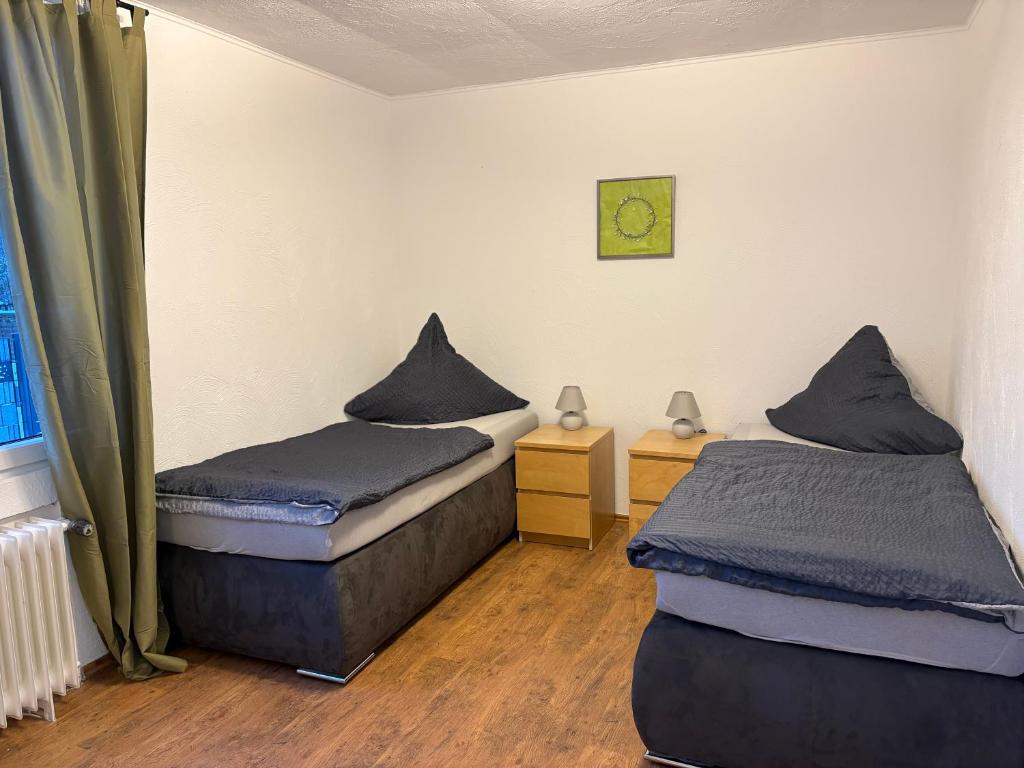 a room with two beds and a clock on the wall at Gästezimmer Flechtorf in Lehre