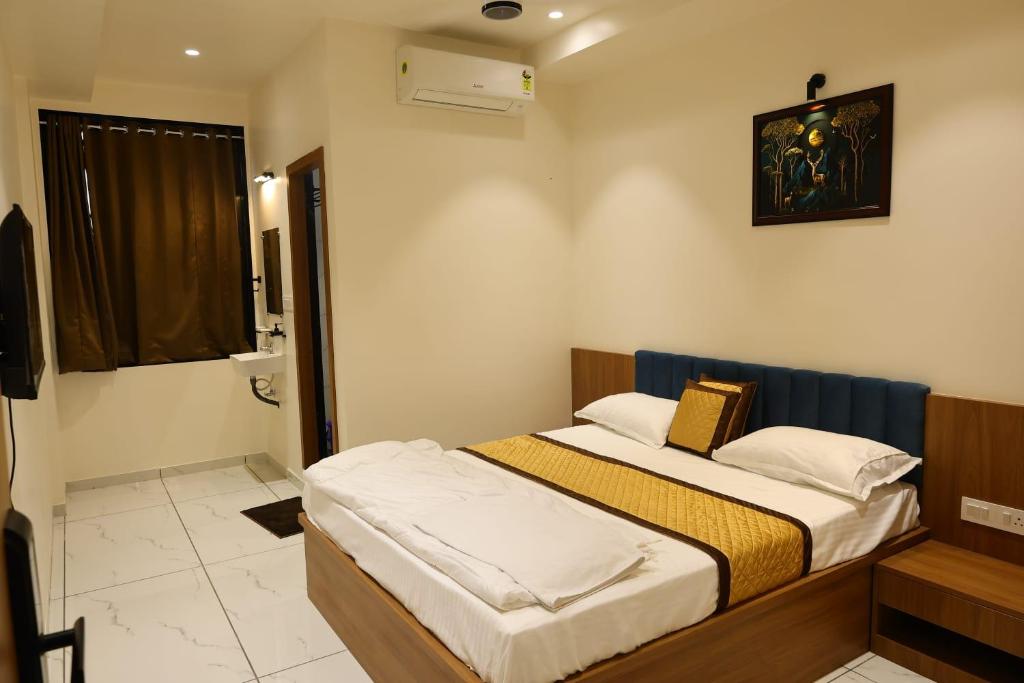 a bedroom with two beds in a room at Rajwadi Hotel Inn in Valsād