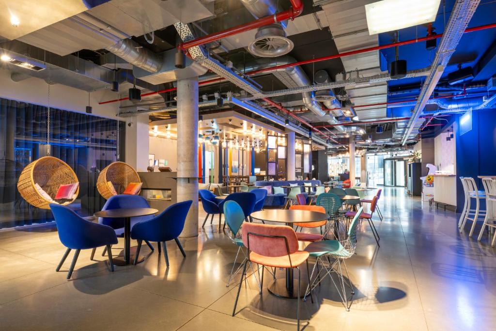 a restaurant with tables and chairs in a room at Pestana Brussels Schuman in Brussels