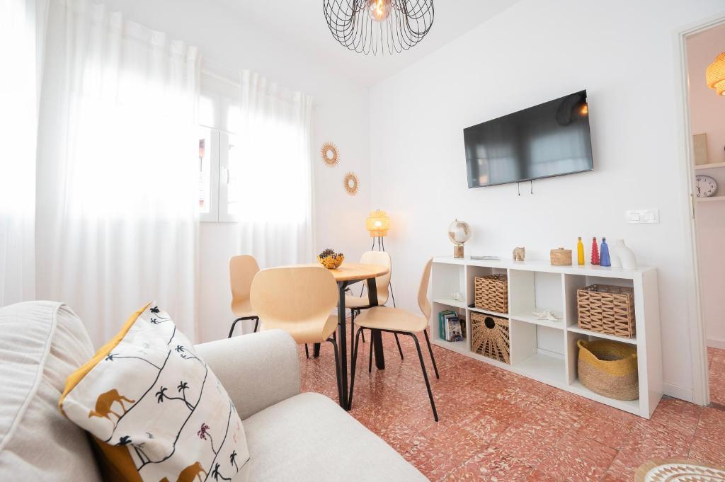 a living room with a white couch and a table at Carlota Cake in Fuencaliente de la Palma