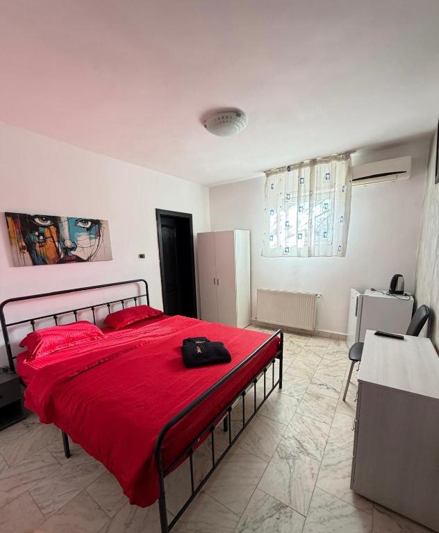a bedroom with a large bed with a red blanket at MLR Residence - Free Private Parking in Timişoara