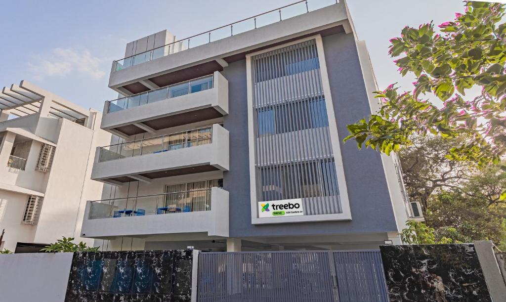 a building with a sign on the side of it at Treebo Atithi Comforts Inn in Pune