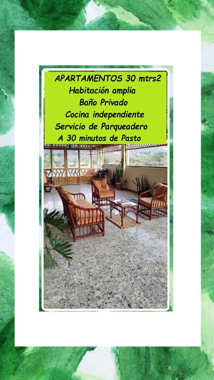 a sign with chairs and tables in a room at El Jardín cerca Aeropuerto de Pasto, comodidad y descanso in Chachagüí
