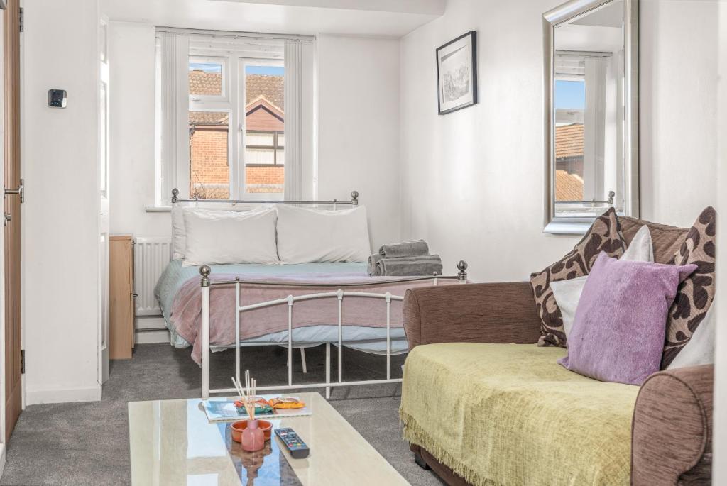 a living room with a couch and a table at Badger Haven, Apartment 1 in Brackley