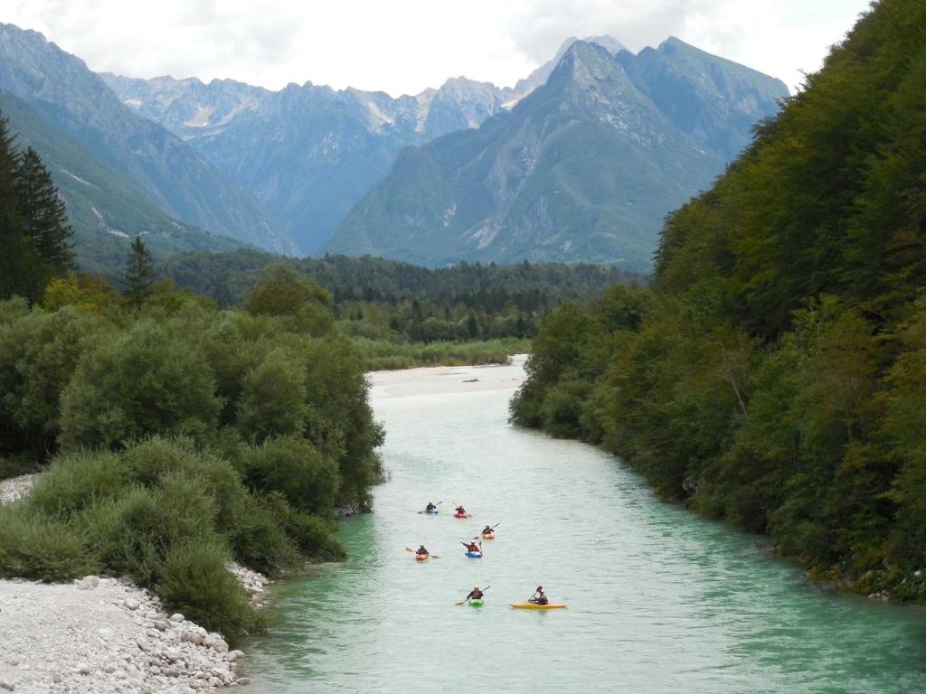 a group of people are rafting down a river at Apartment House Cviter in Bovec
