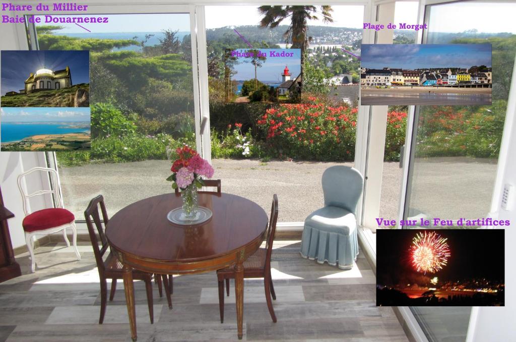 a table and chairs in a room with a window at Studio vue mer dans le centre de Crozon in Crozon