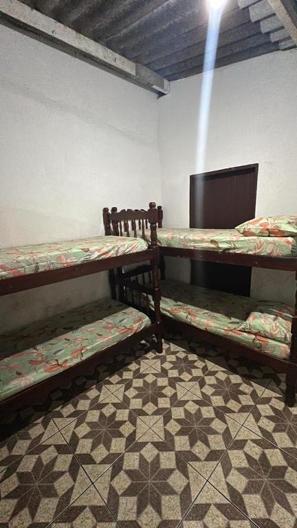two bunk beds in a room with a fireplace at Casa da Biza 1 in Cananéia