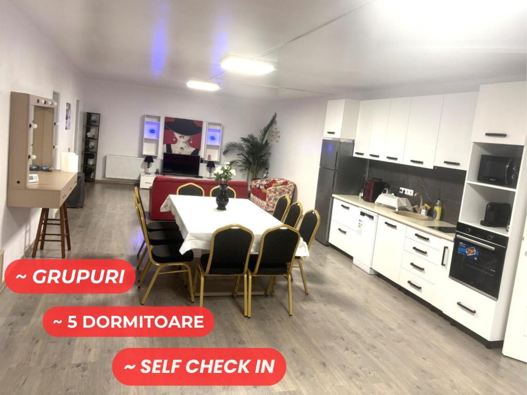 a kitchen and dining room with a table and chairs at Bob Residence- Chic Penthouse in Cluj-Napoca