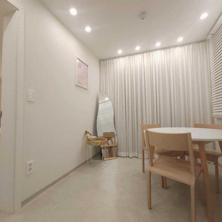 a dining room with a table and chairs at COZY stay in Seoul