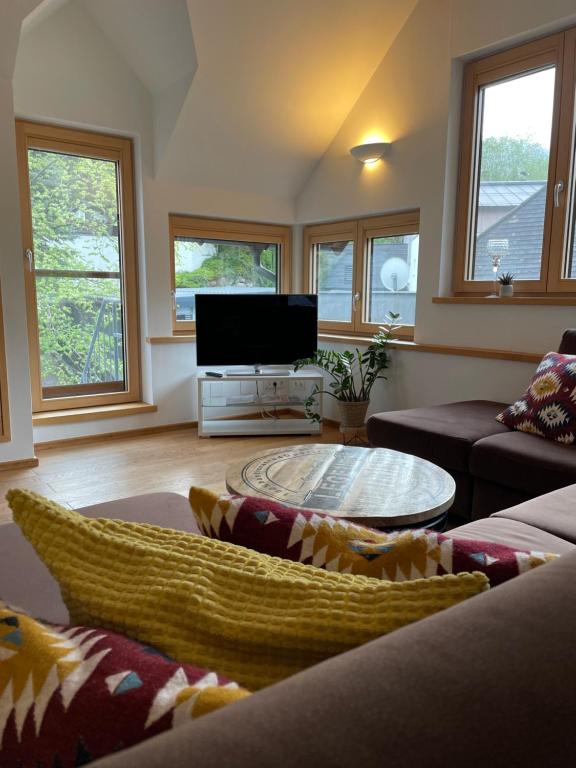 a living room with a couch and a flat screen tv at Grosses Apartment im Krämerhaus in Annaberg , 4 Schlafzimmer, 2 Badezimmer, 8 Personen, Zentrum in Annaberg im Lammertal