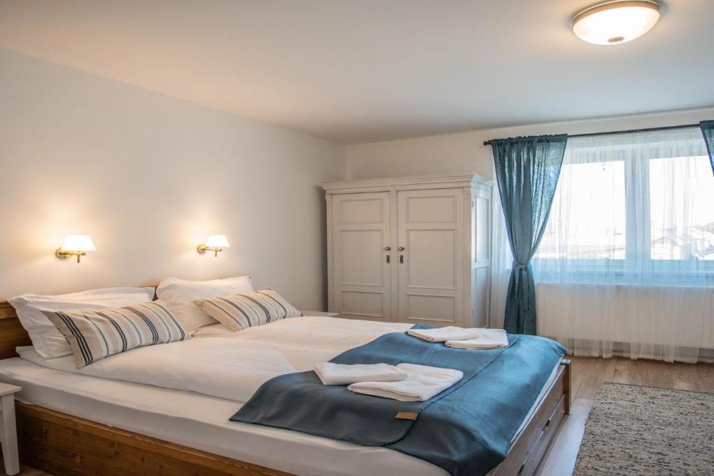a bedroom with a large bed with two towels on it at Tündérliget in Egerszalók
