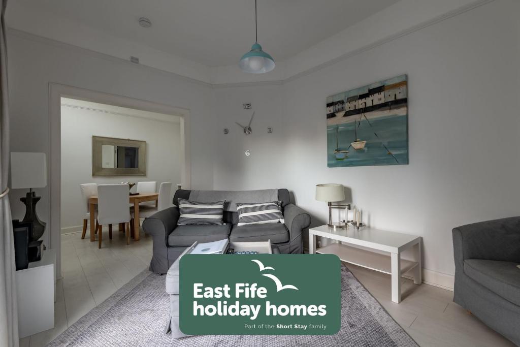 a living room with a couch and a table at Bakers Close - Elie in Elie