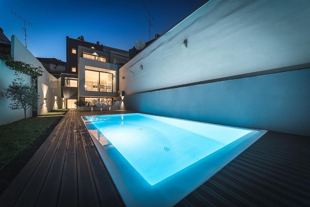 a swimming pool in the backyard of a house at Bom Jardim Apartments in Porto
