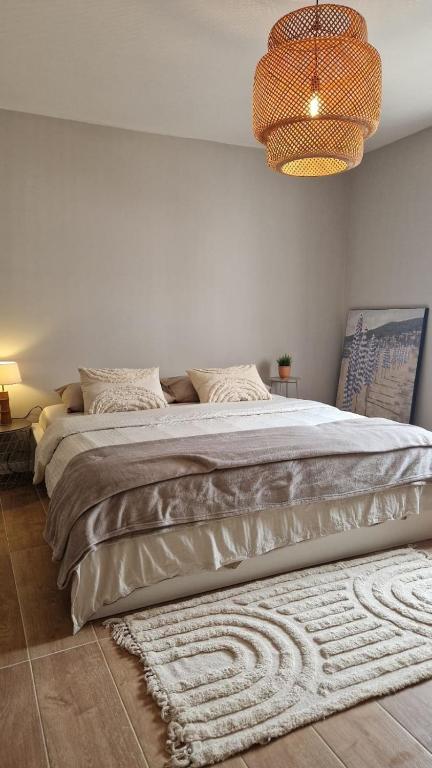 a bedroom with a large bed with a rug at Meu Sonho Cascais - Praia in Alcabideche