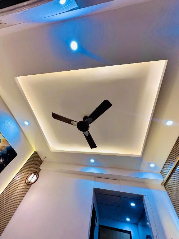 a ceiling with a ceiling fan in a room at Urban Luxury Studio Apartment in Greater Noida