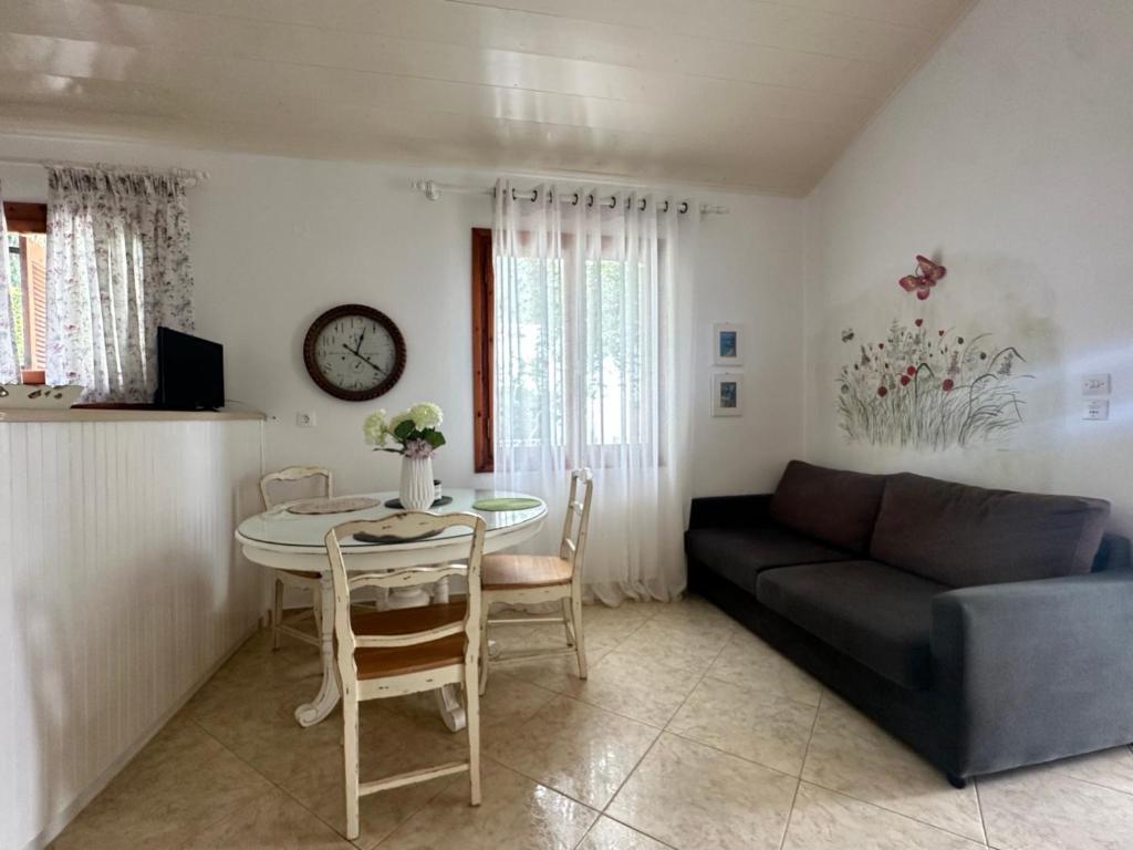 a living room with a couch and a table at Achladies Cottages in Achladies