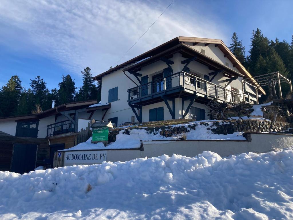 a house with snow in front of it at Au Domaine de PY in Le Valtin