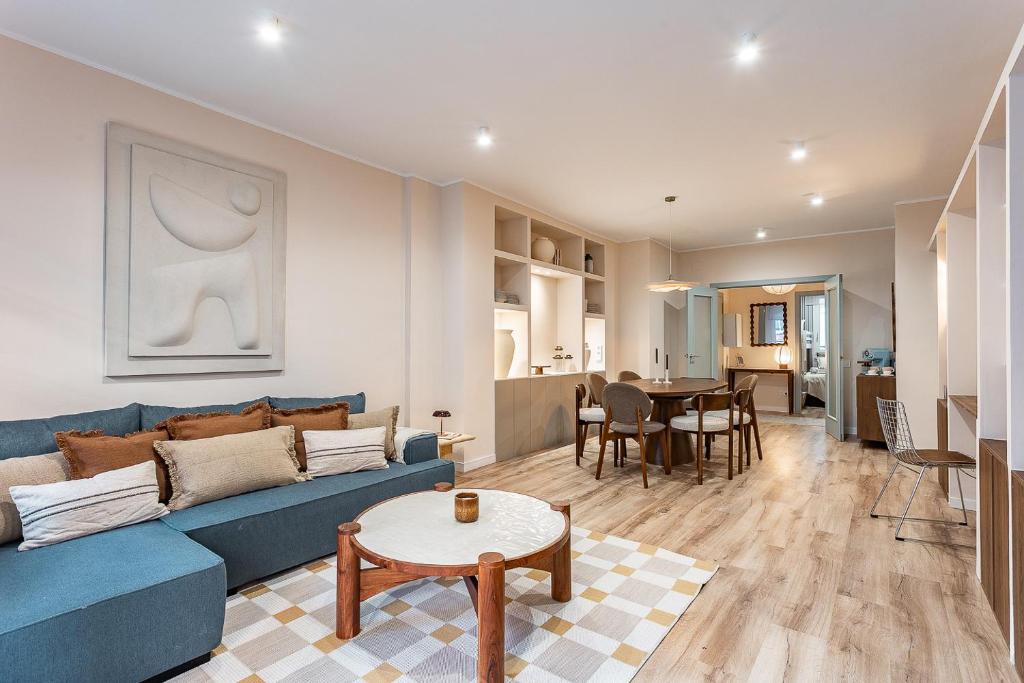 a living room with a blue couch and a table at Comfortable and spacious flat in Barcelona in Barcelona