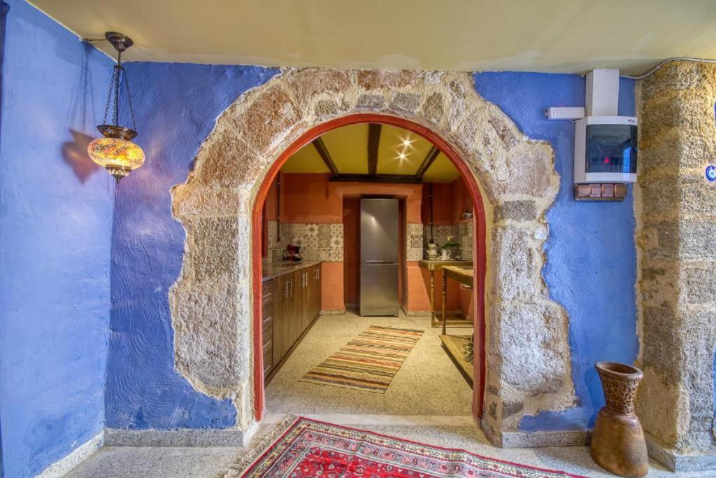 an archway in a kitchen with a blue wall at Fatma Hanoum Old Town in Rhodes Town