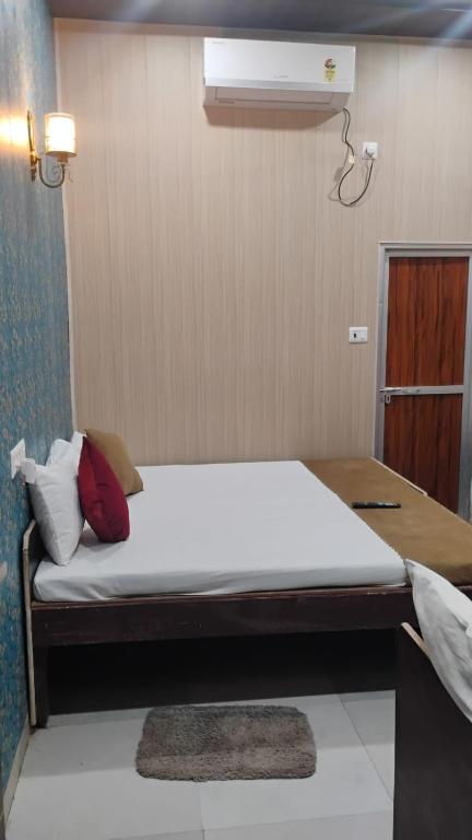 a bed in a room with a white mattress at ANAND LOK VARANASI in Varanasi