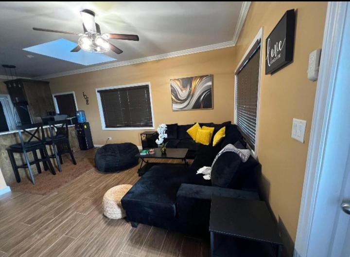a living room with a couch and a ceiling fan at Vacation Haven Cottages in Rolleville