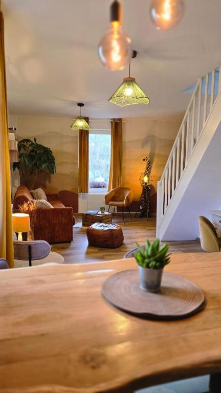 a living room with a couch and a table at Le Royal Billy in Dreux