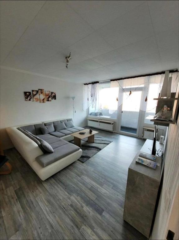 a living room with a couch and a table at Sarra&Mo Ferienwohnung in Duisburg