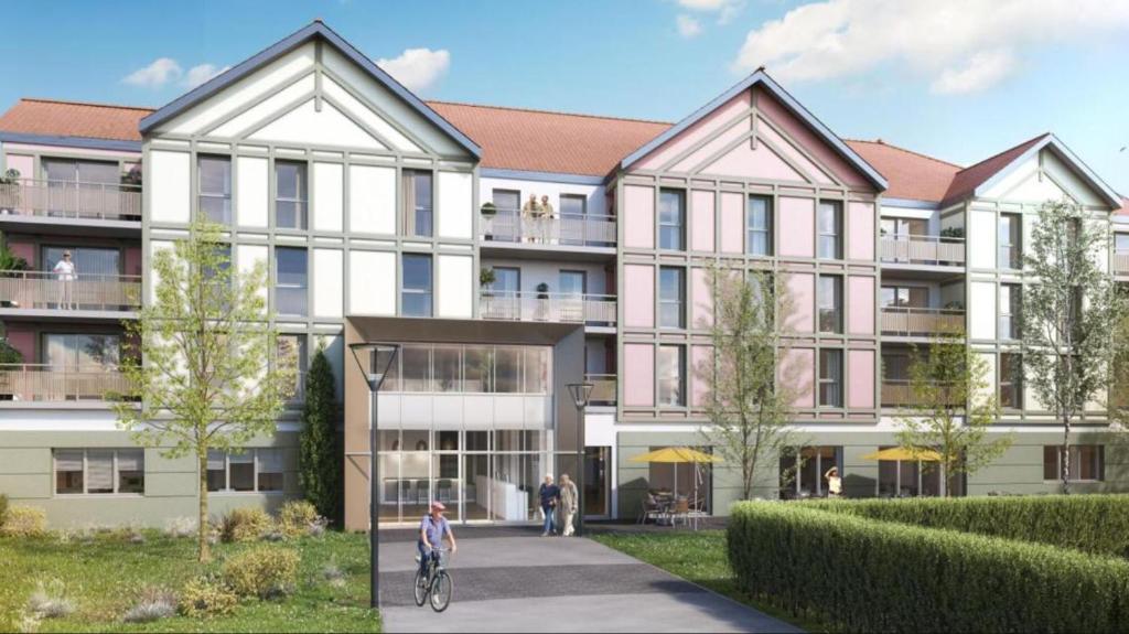 a rendering of a building with a person riding a bike at DOMITYS - L'Elyme des sables in Neufchâtel-Hardelot