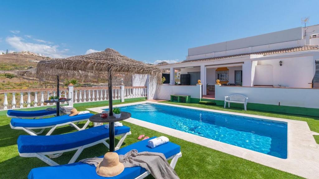 a villa with a swimming pool and a house at Villa Quevedo Torrox by Ruralidays in Torrox