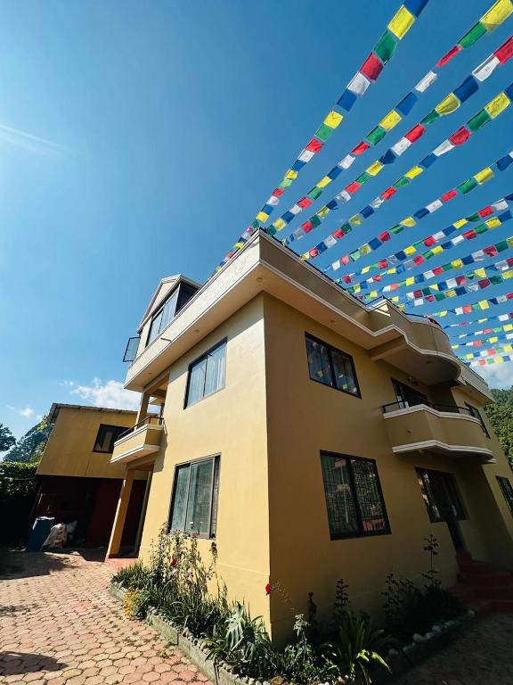 a house with colorful flags on top of it at Pharping StayInn in Pharping