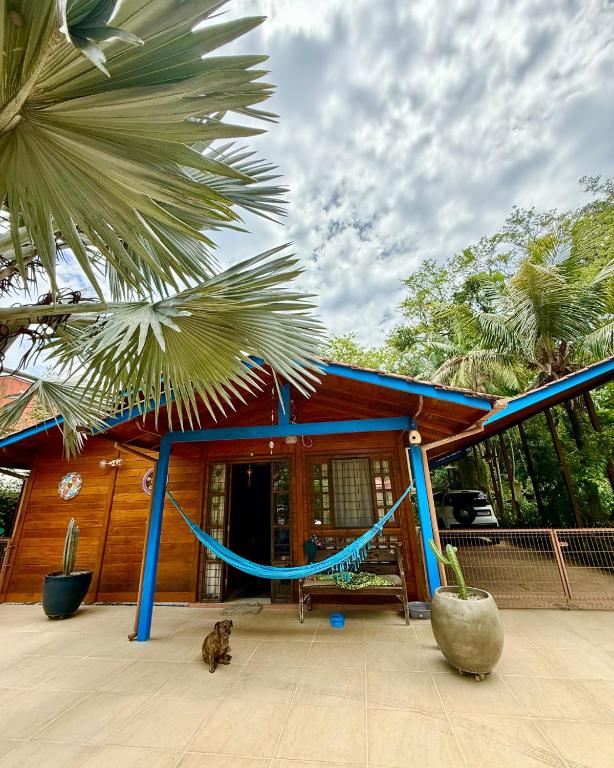 a house with a hammock in front of it at EcoVibe House Florianópolis in Florianópolis