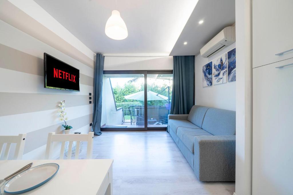 a living room with a couch and a table at Desenzano - 2' to Station & Lake - Pool, Wifi, AC in Desenzano del Garda