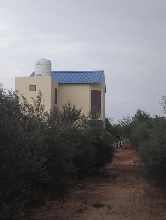 a small white building with a satellite at Maanjoofarms Pilani in Pilani