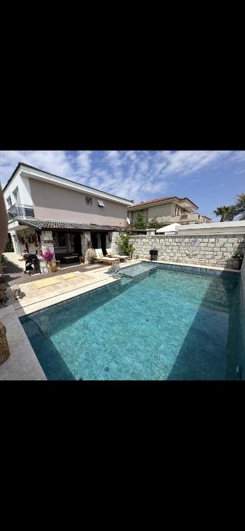 a large swimming pool in front of a house at Eos in Çeşme