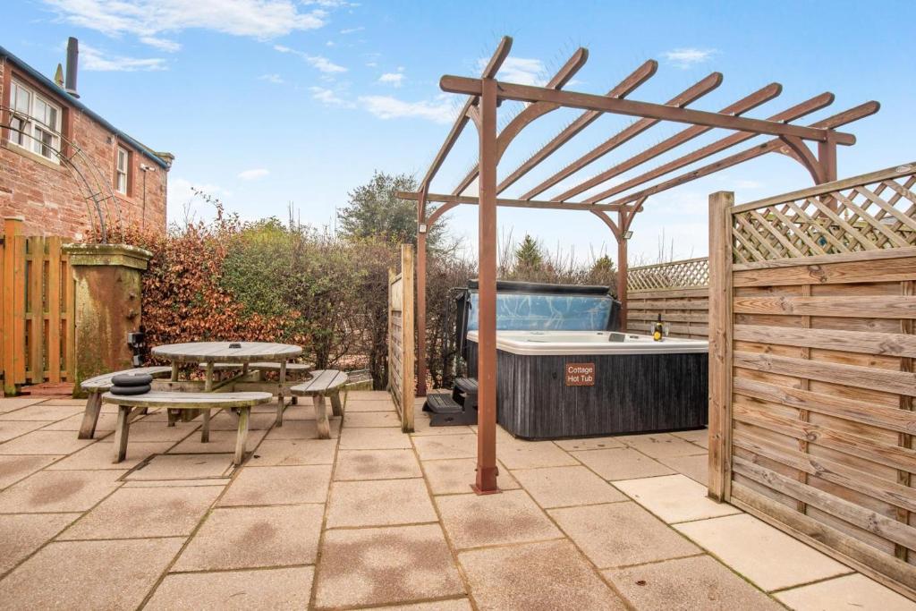 a wooden pergola with a picnic table and a tub at 3 Bed in Brampton oc-g34639 in Brampton