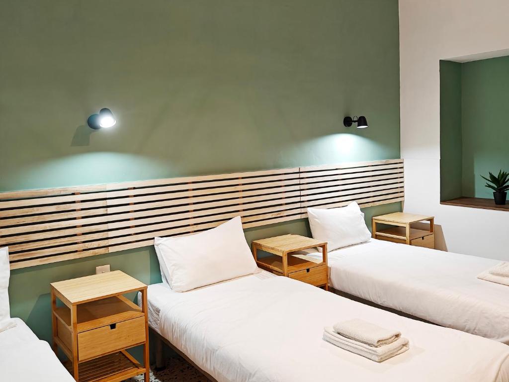 a room with three beds with white pillows at Cosyroom 3 in Pieta