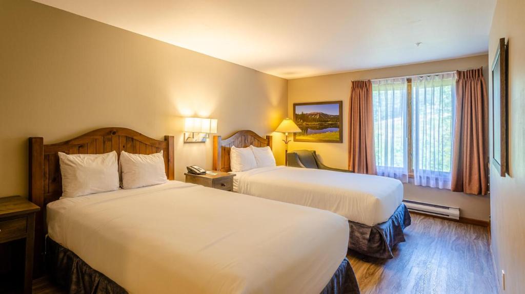 a hotel room with two beds and a window at Cahilty #313 home in Sun Peaks