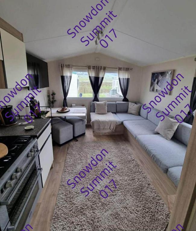 a living room with purple writing on the floor at Snowdon Summit 017 in Barmouth
