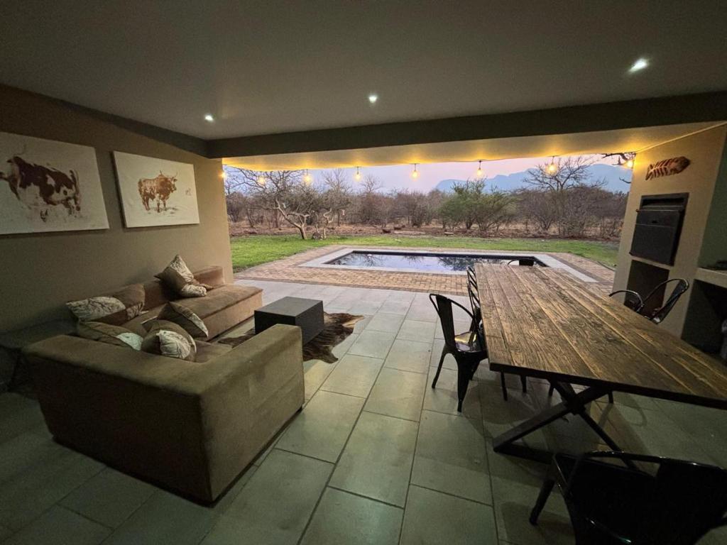 a living room with a couch and a table at House 110 in Hoedspruit